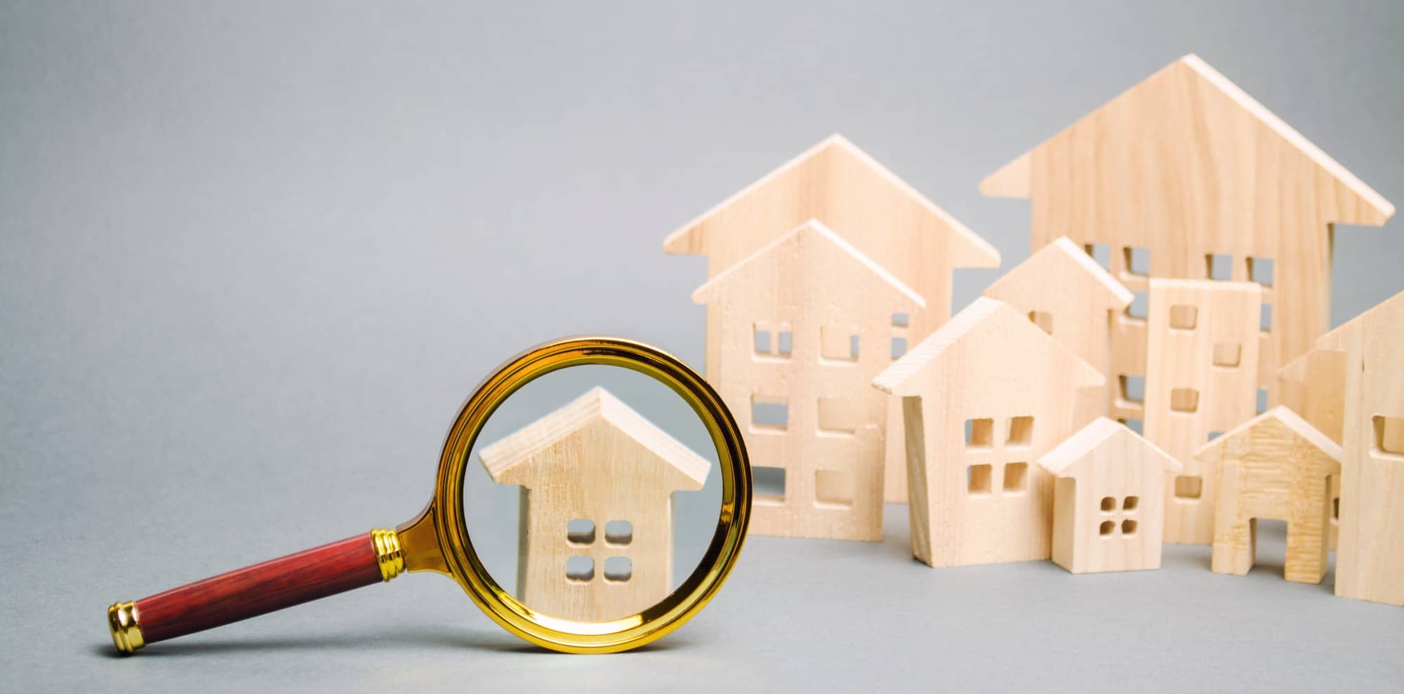 Magnifying glass and wooden houses